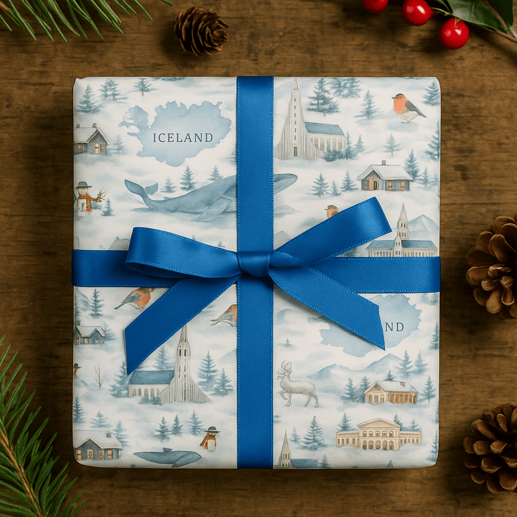 Luxury Iceland Christmas wrapping paper featuring watercolor designs of landscapes and village scenes, tied with a blue ribbon.
