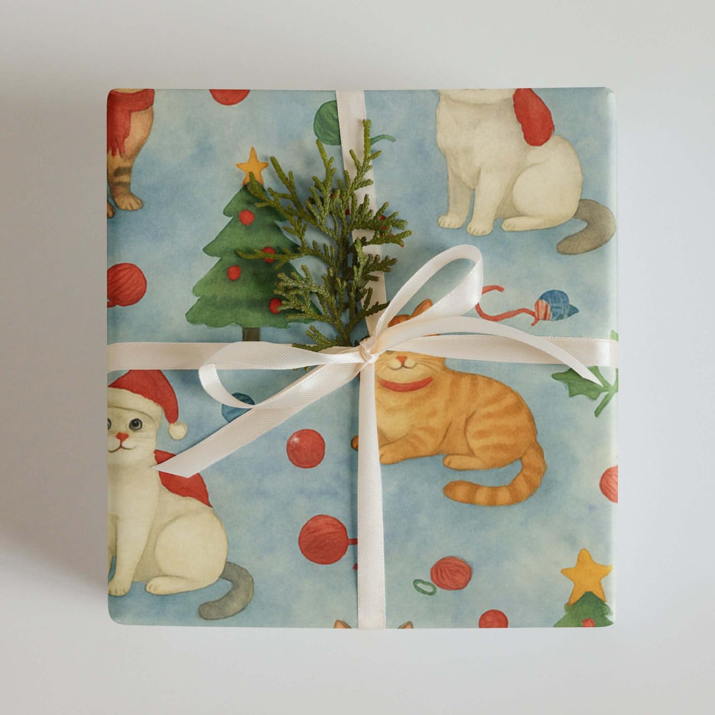 Luxury Christmas wrapping paper featuring playful watercolor cats in festive attire with Christmas decor.