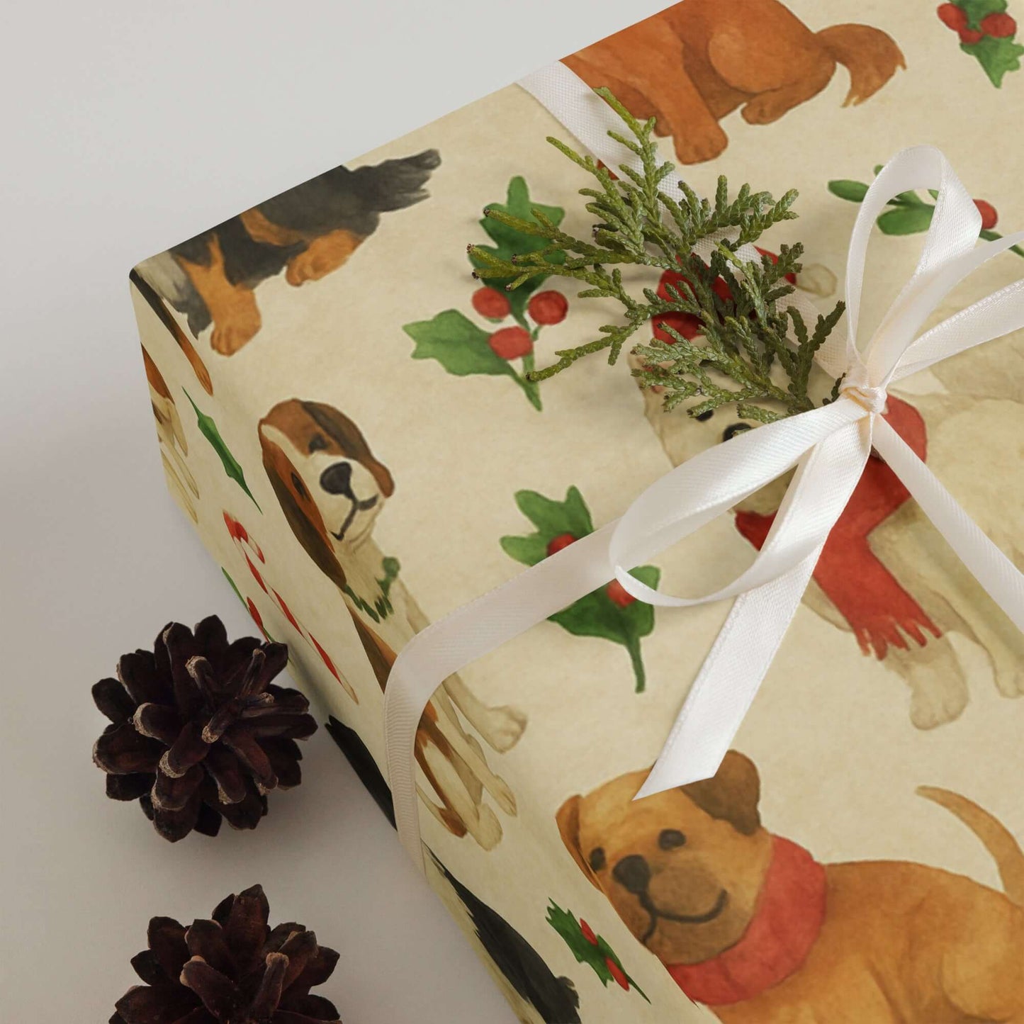 Luxury Christmas wrapping paper featuring watercolor dogs in festive attire with holly and pine accents.