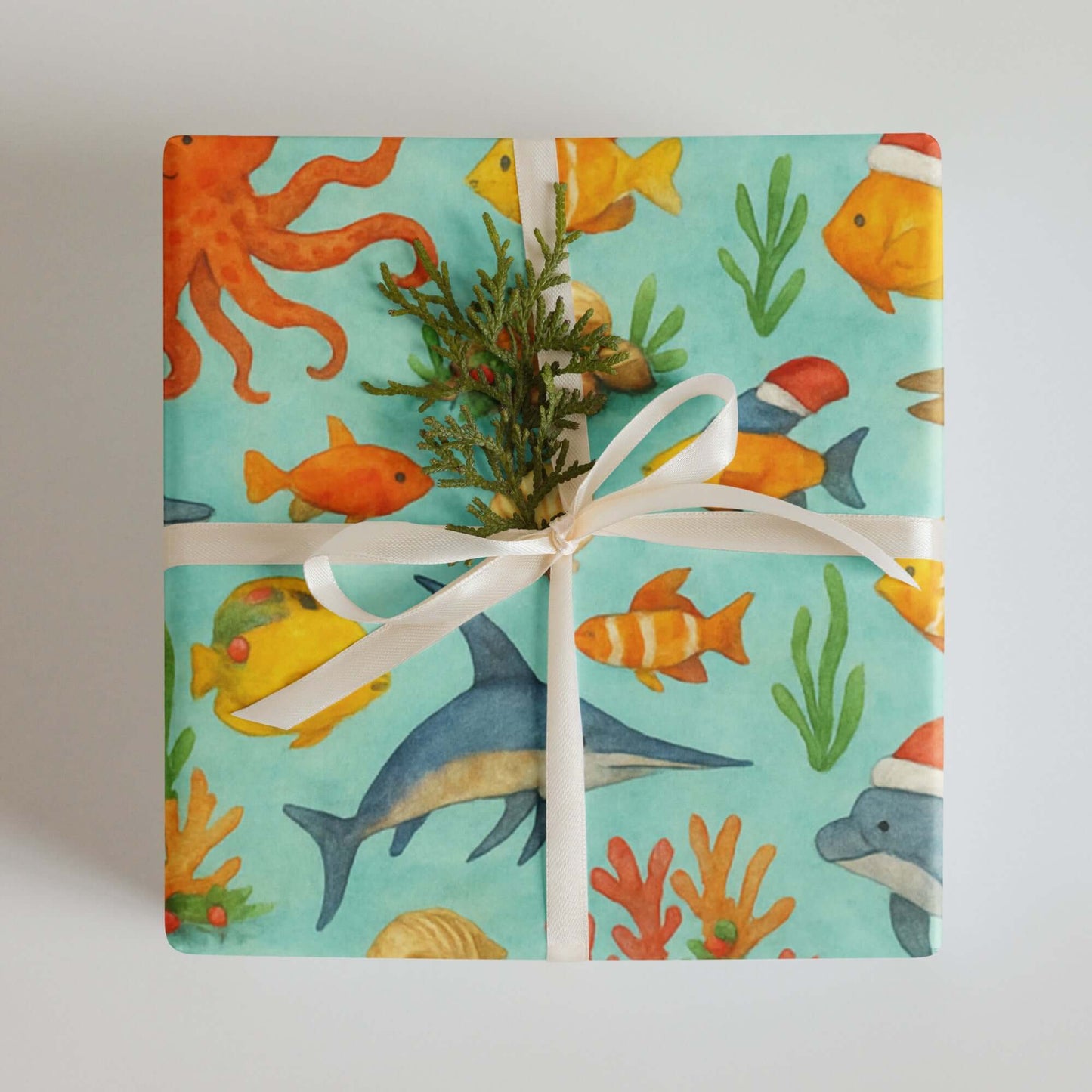 Luxury holiday gift wrap featuring colorful sea creatures and coral design in watercolor style.
