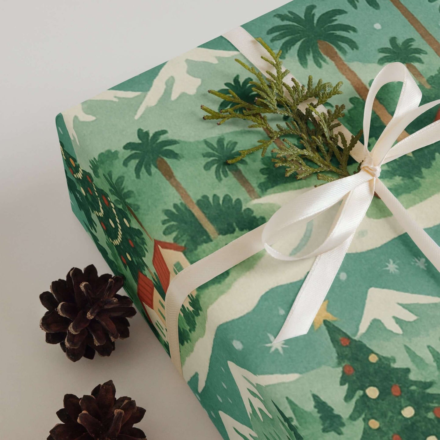 Luxury Christmas wrapping paper with watercolor design, featuring coastal palm trees and snowy mountains.