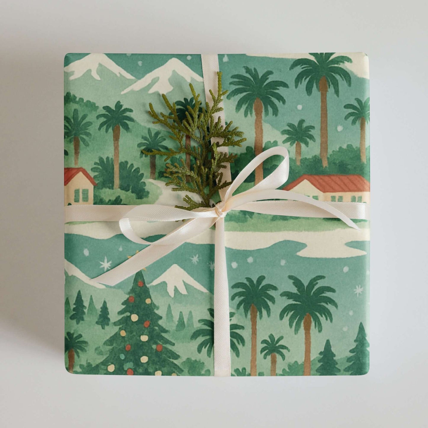 Luxury Christmas wrapping paper featuring watercolor palm trees and snowy mountains, eco-friendly and made in the USA.