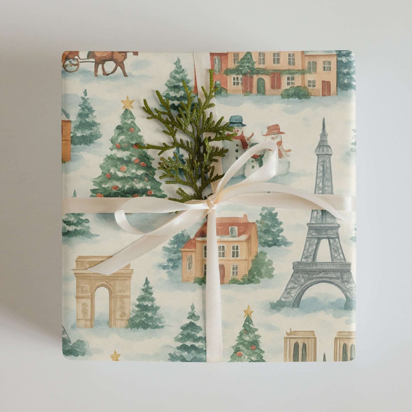 Luxury Christmas wrapping paper featuring Paris landmarks in watercolor design, adorned with greenery and festive elements.