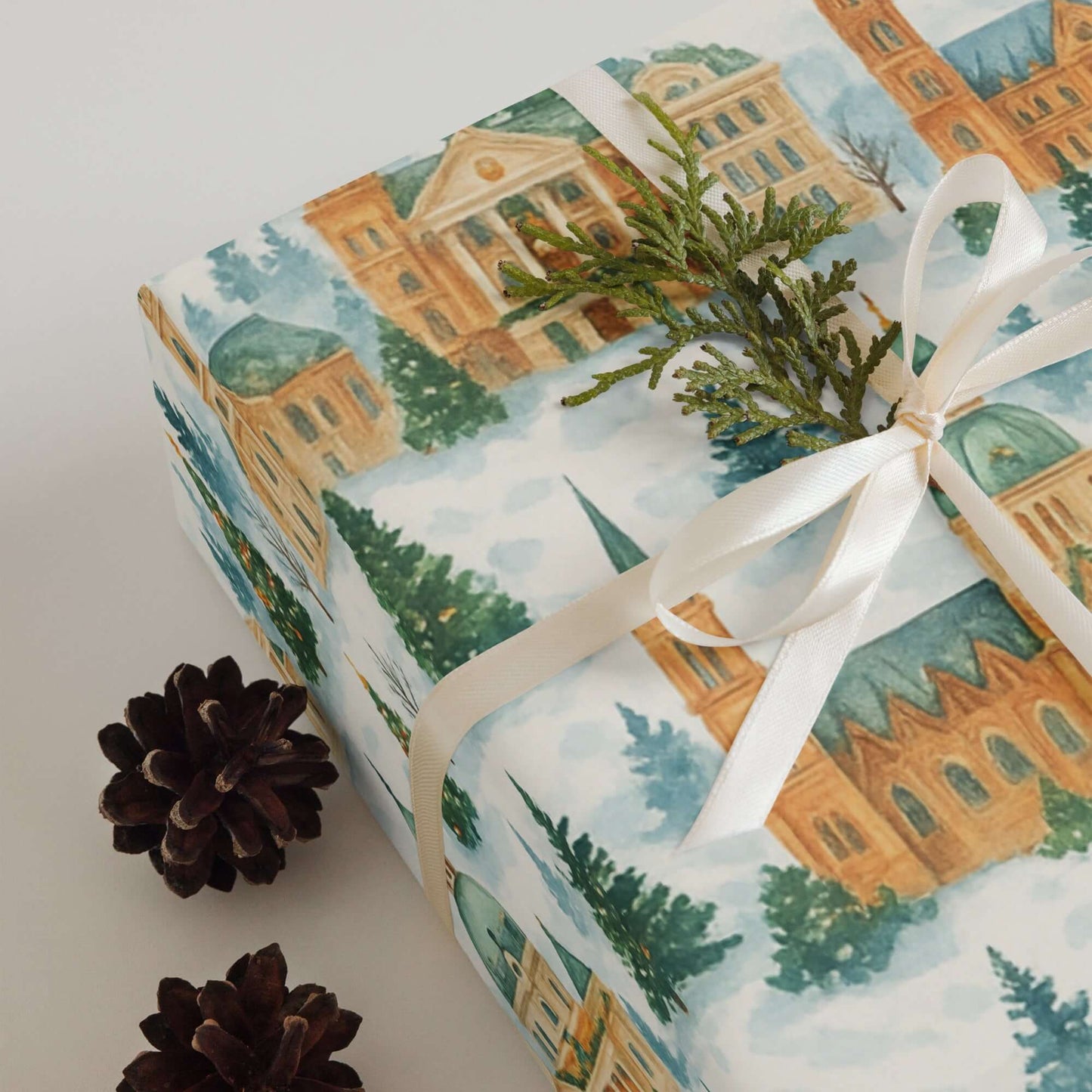 Luxury Christmas wrapping paper featuring watercolor design of iconic Venice landmarks, tied with a ribbon and greenery.