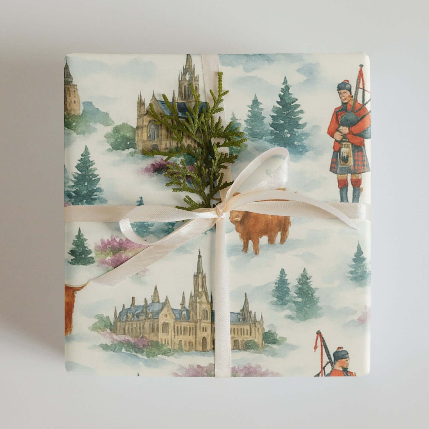 Scotland Christmas wrapping paper with watercolor Highland scenes and a bagpiper, decorated with natural accents.