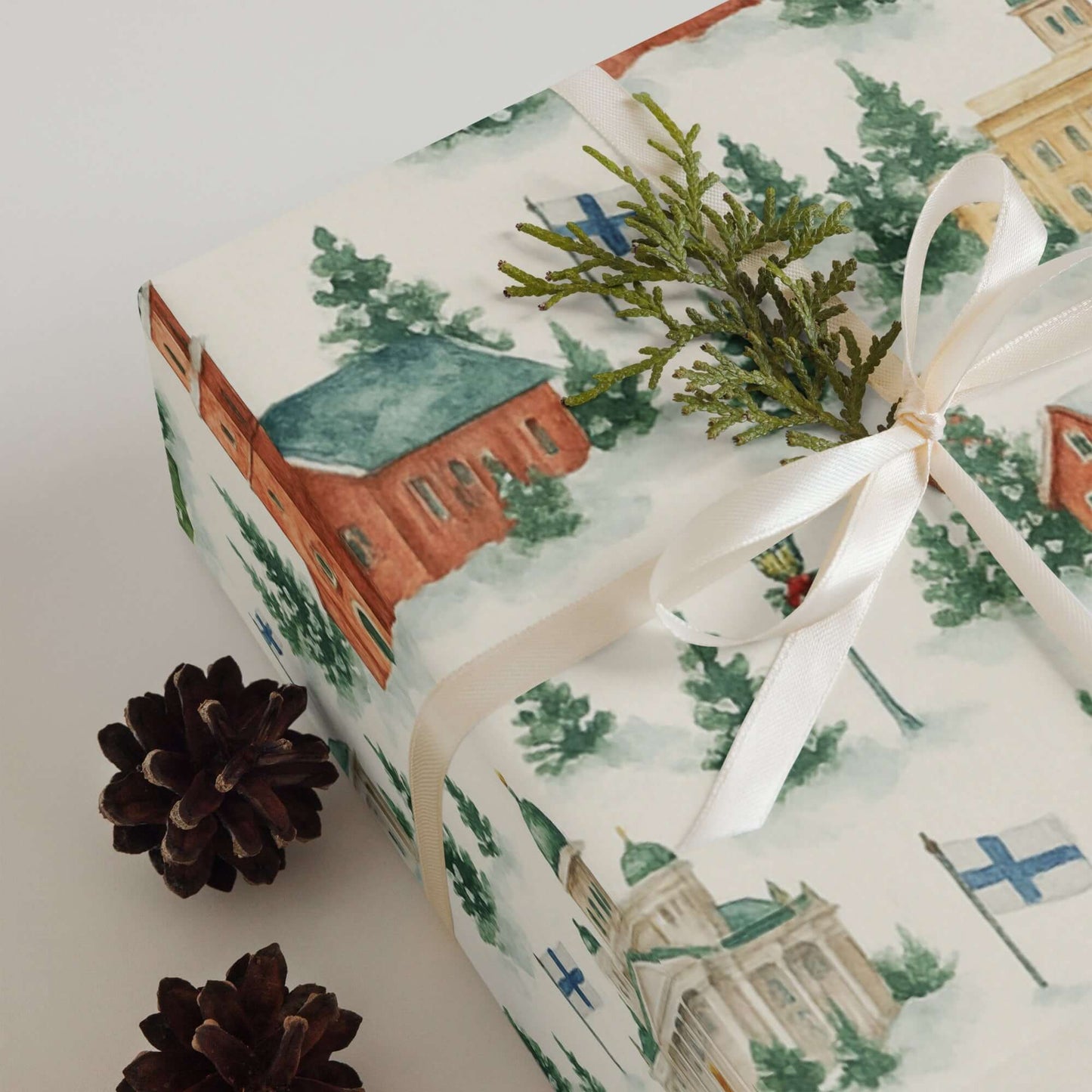 Luxury Christmas wrapping paper with watercolor design featuring Finnish landmarks and greenery.