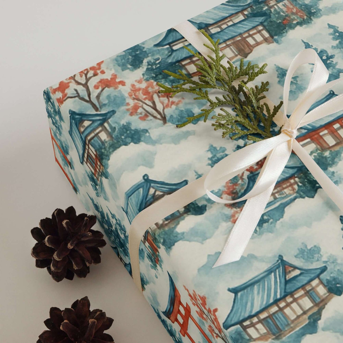Luxury Christmas wrapping paper featuring watercolor Japanese landscape design, adorned with festive greenery.