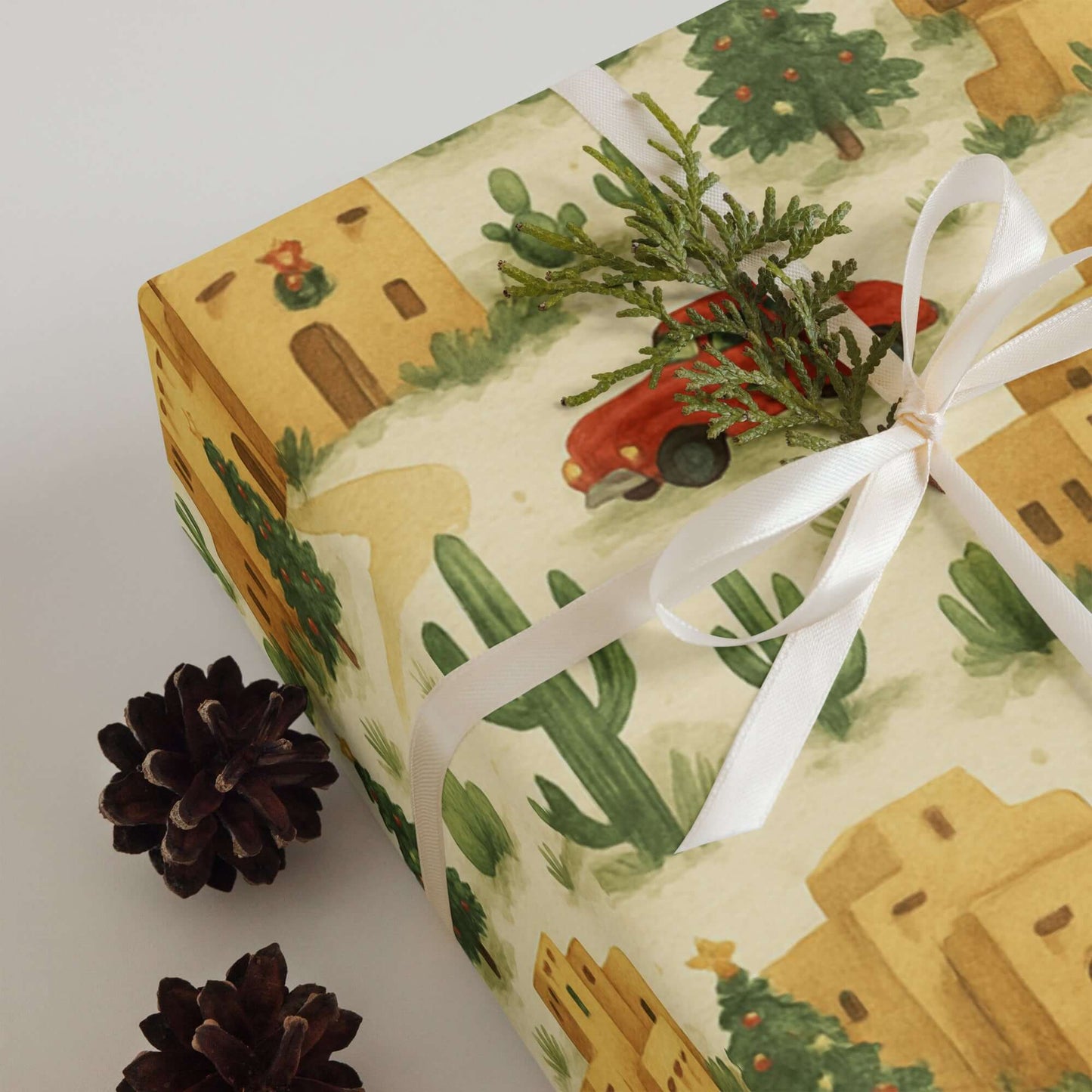 Adobe Pueblo Christmas wrapping paper with watercolor design, cacti, and vintage truck.