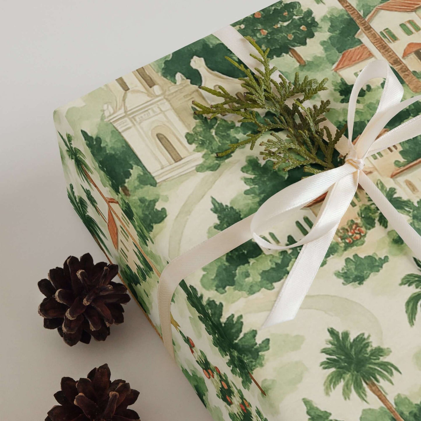 Luxury Christmas wrapping paper featuring Southern California homes and palm trees, adorned with greenery.