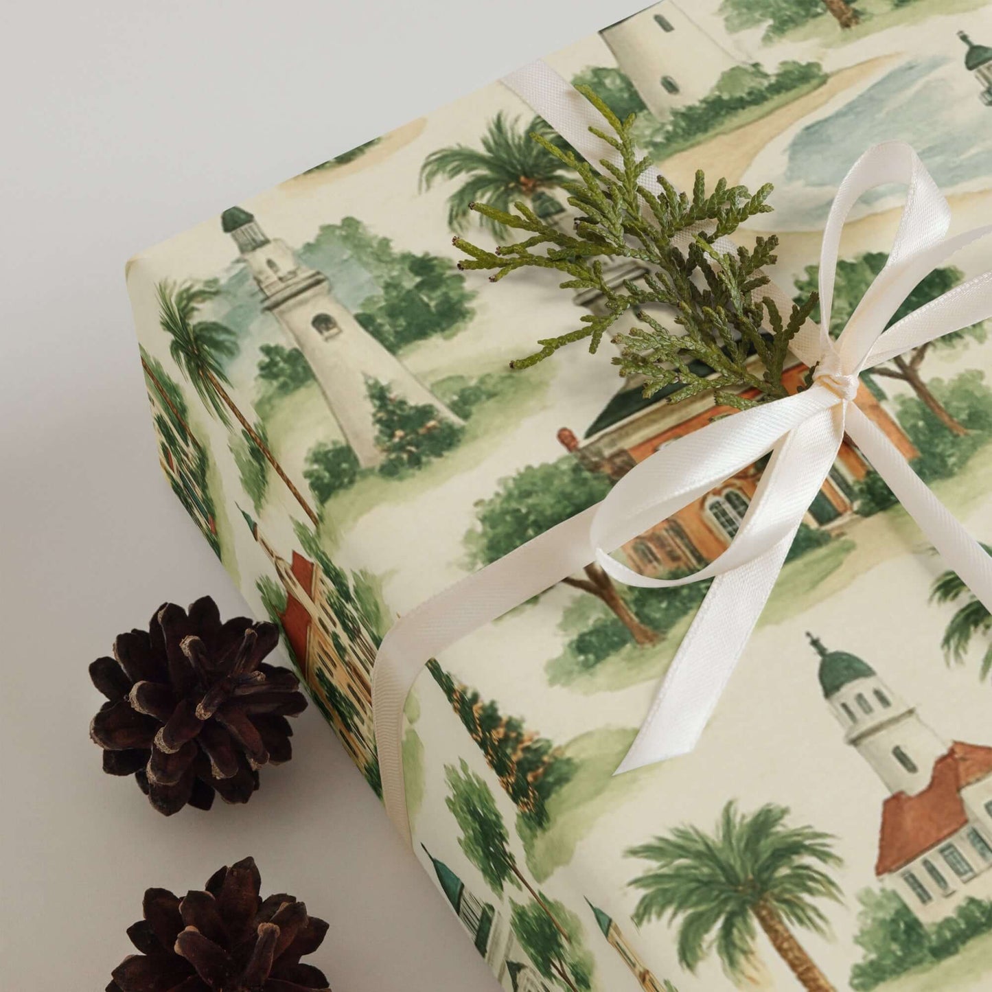 Luxury Christmas wrapping paper featuring coastal lighthouses and greenery in a watercolor design.