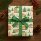 Luxury Christmas wrapping paper featuring quaint watercolor village scenes and festive trees, elegantly tied with a green ribbon.