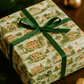 Luxury Christmas wrapping paper featuring Southern plantations in watercolor style, adorned with a green ribbon.