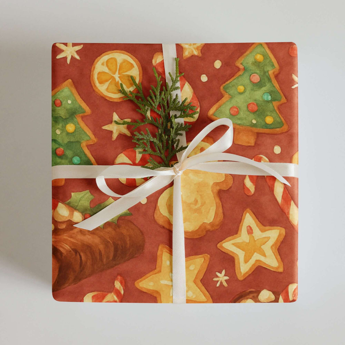 Baking Christmas Wrapping Paper featuring festive holiday designs of cookies, trees, and candy canes on a rich red background.