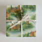 Denmark Wrapping Paper featuring soft watercolor cityscapes with a bow and greenery, perfect for elegant gift wrapping.