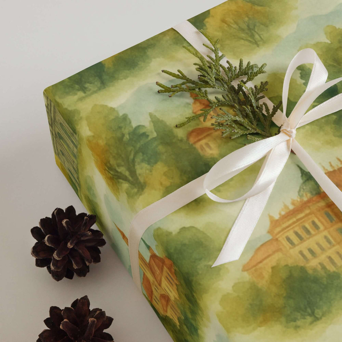 Madrid Wrapping Paper adorned with greenery and a ribbon, featuring hand-painted landmarks in beautiful colors.