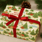 Luxury Christmas wrapping paper featuring tropical design with palm trees, snowman, and festive poinsettias.