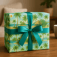 Serene beach wrapping paper with tropical palm design, ribbon, and eco-friendly packaging on wooden table.