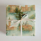 Venice Wrapping Paper featuring watercolor illustrations of Venetian architecture and gondolas tied with a ribbon and greenery.