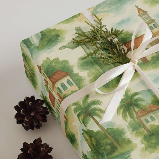 South America Wrapping Paper featuring lush greenery and charming colonial buildings, beautifully tied with a ribbon.