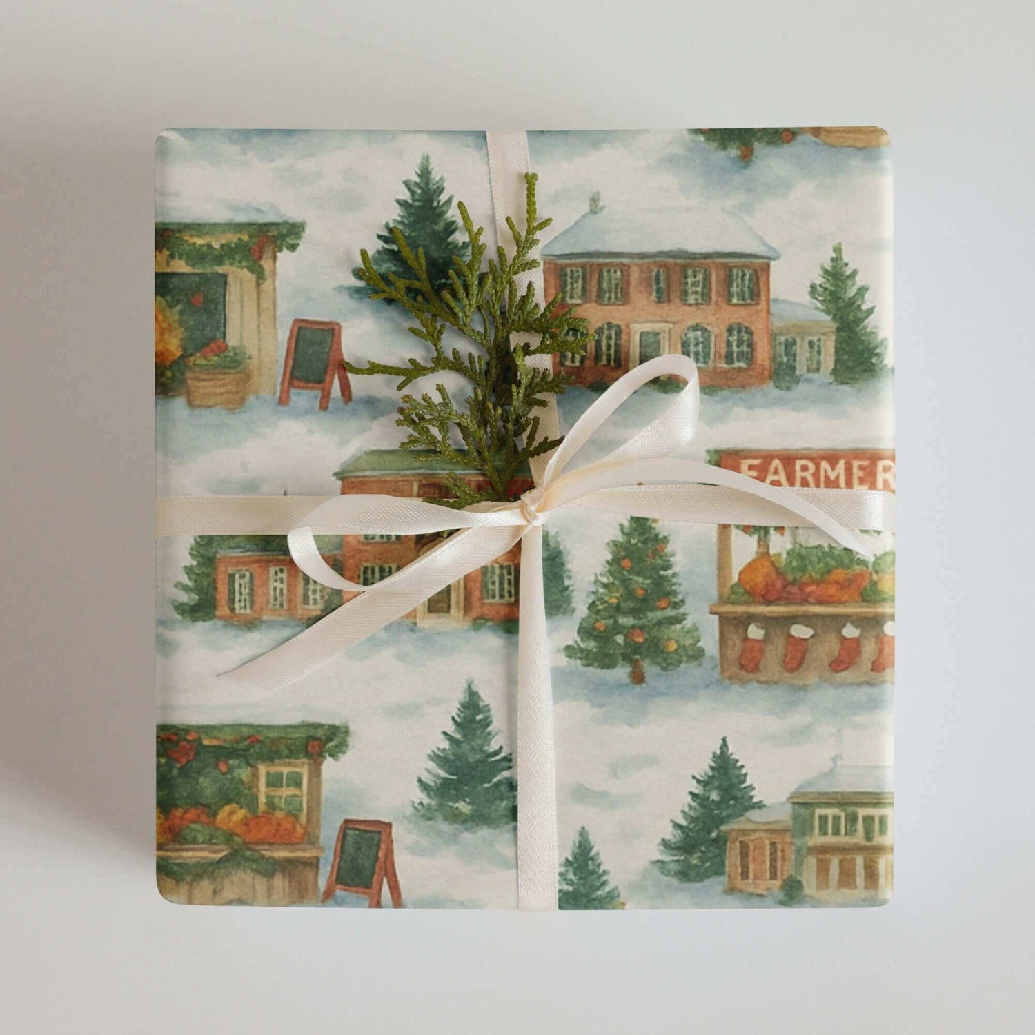 Luxury Christmas wrapping paper featuring a watercolor farmers market scene with festive wooden stalls and greenery accents.