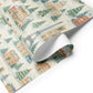 Luxurious Christmas wrapping paper featuring watercolor Parisian landmarks, snowy trees, and festive holiday charm.