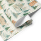 Luxurious Copenhagen Christmas wrapping paper features watercolor illustrations of historic buildings and pine trees.