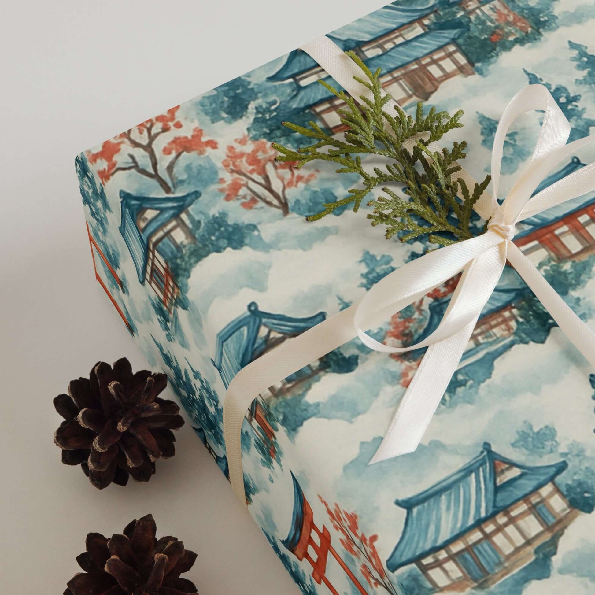 Luxury Christmas wrapping paper featuring watercolor Japanese landscape design, adorned with festive greenery.