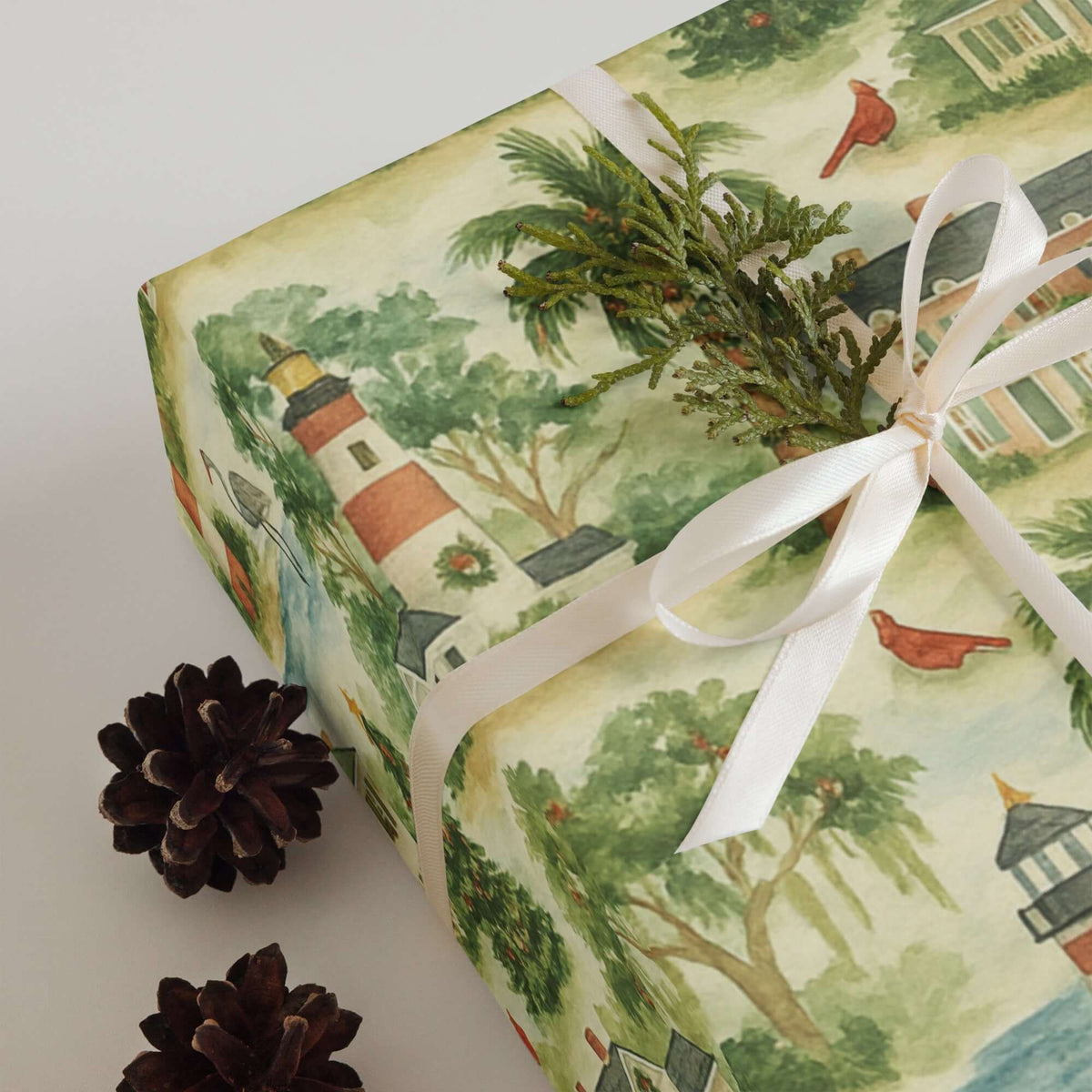 Luxury Christmas wrapping paper featuring watercolor coastal lighthouses and festive foliage, perfect for holiday gift wrap.