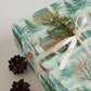 Luxury New England-themed Christmas wrapping paper in watercolor style with pine accents.
