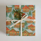 European Christmas Market Wrapping Paper featuring cozy village chalets and festive decorations.