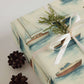 Boats Wrapping Paper featuring hand-painted sailboats and yachts tied with a ribbon, perfect for coastal-themed gifts.